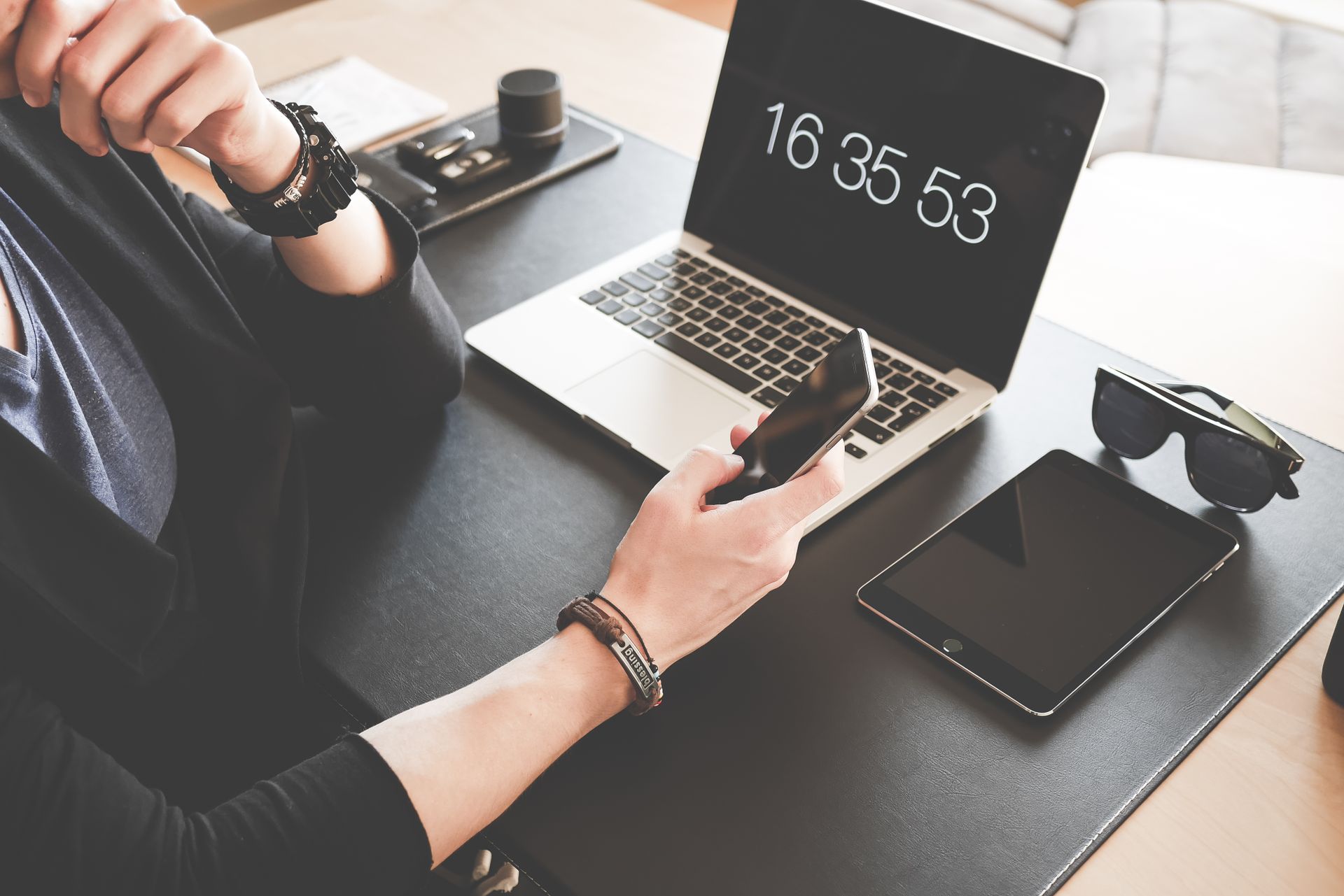 Reviewing work on a laptop and phone